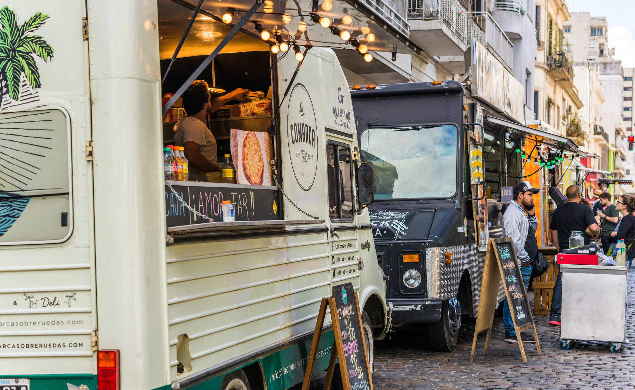 food trucks parked next to each other on a street