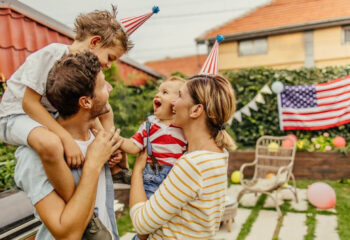 family of four celebrating fourth of july in a backyard