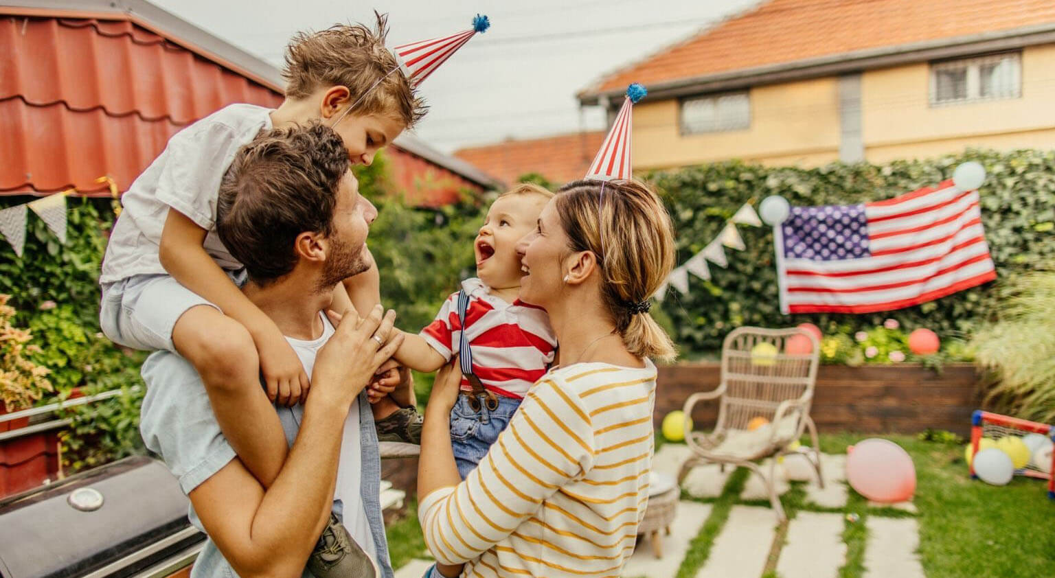 family of four celebrating fourth of july in a backyard