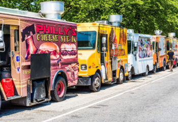row of colorful food trucks with different names