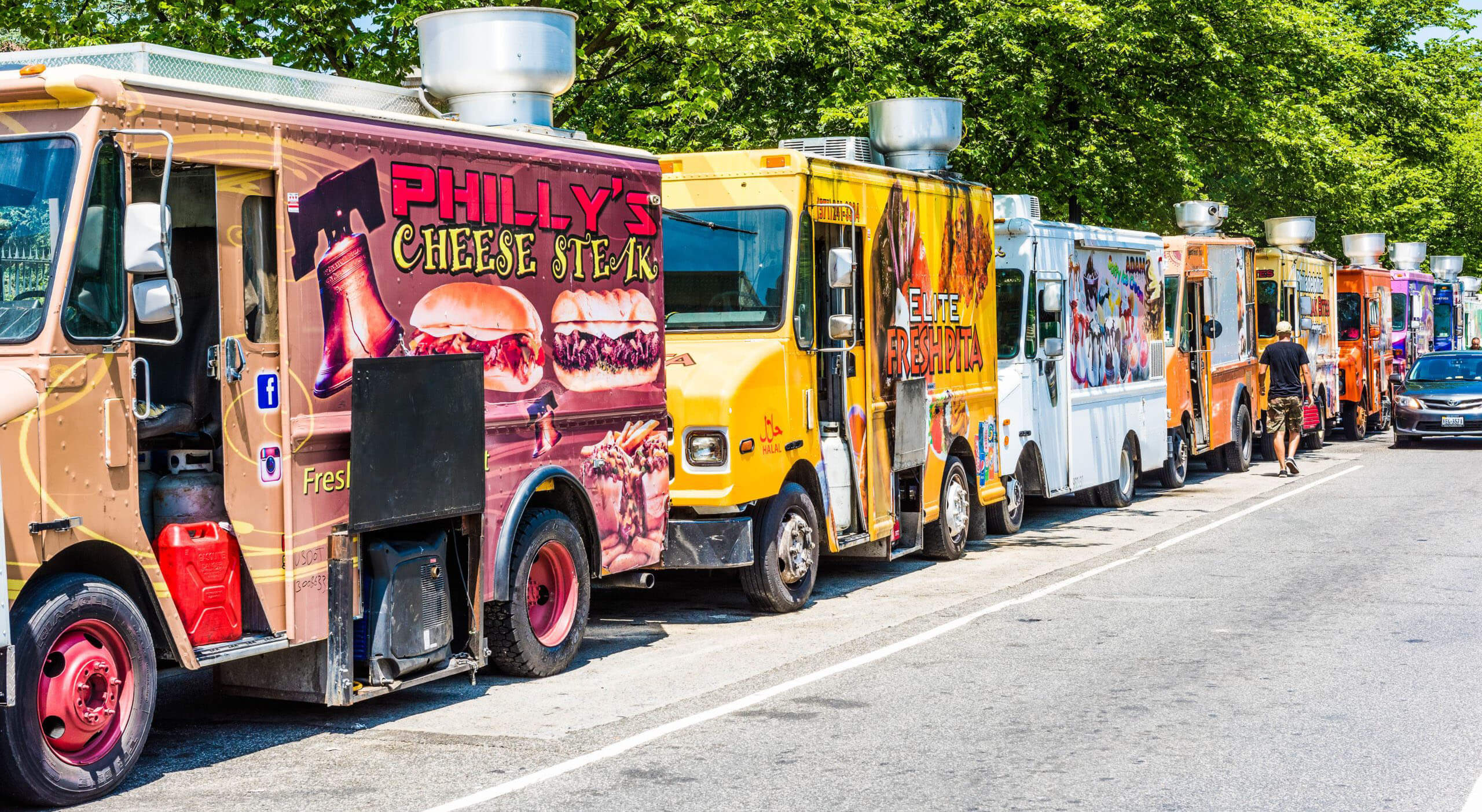 row of colorful food trucks with different names