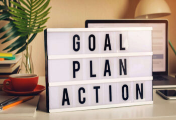 words on a desk saying goal, plan, action