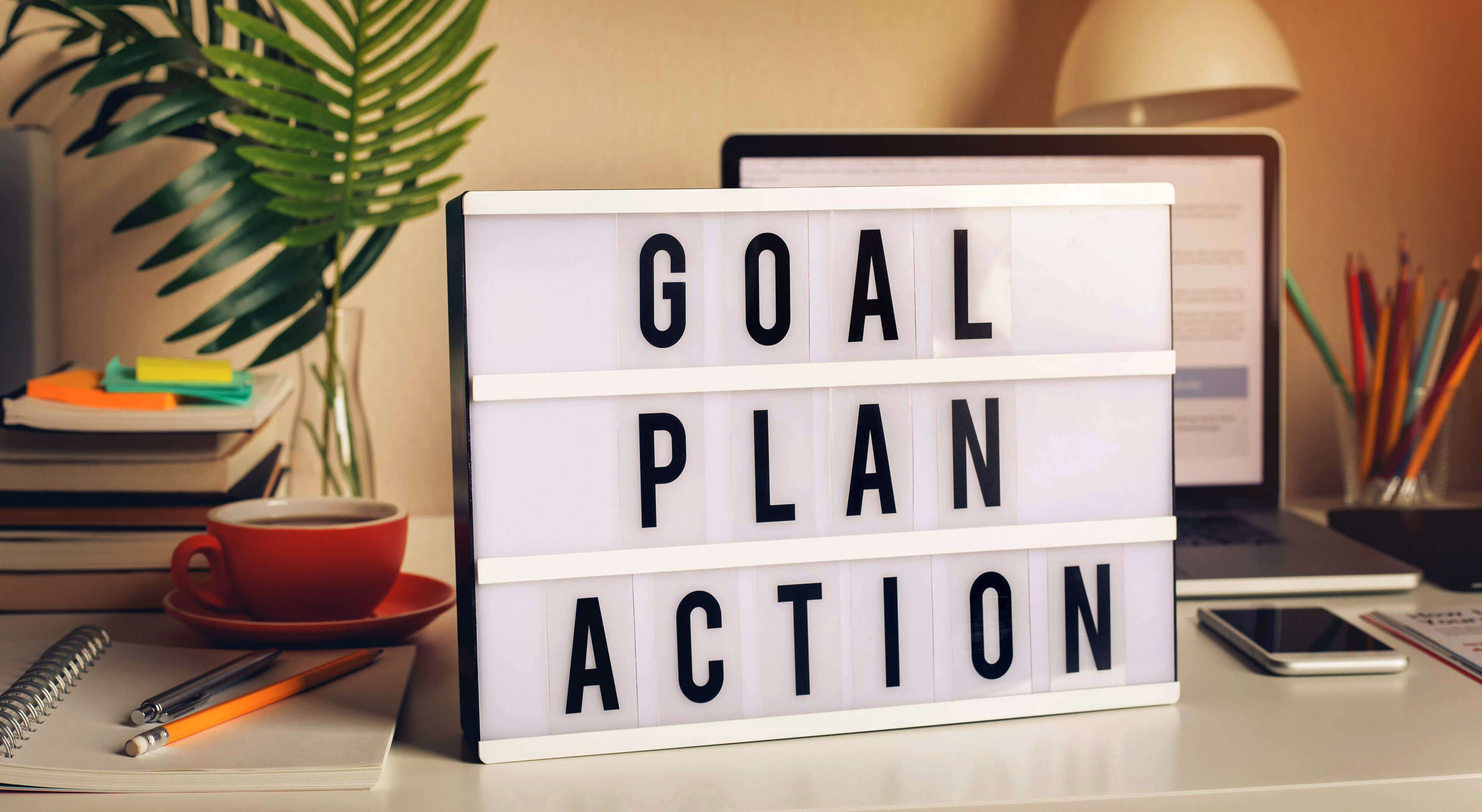 words on a desk saying goal, plan, action