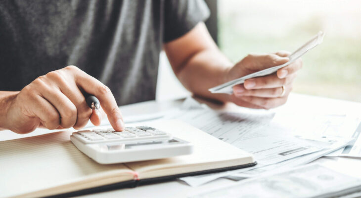 man calculating costs for a food truck business