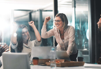 employees in an office celebrating success