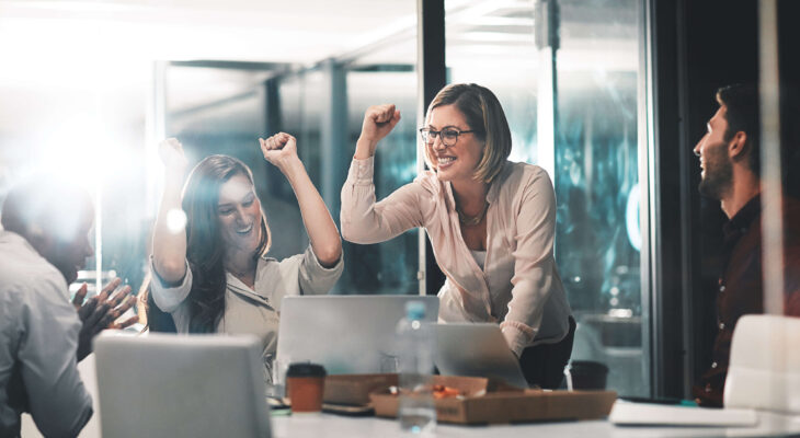 employees in an office celebrating success