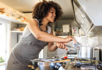 woman preparing food in a food truck kitchen