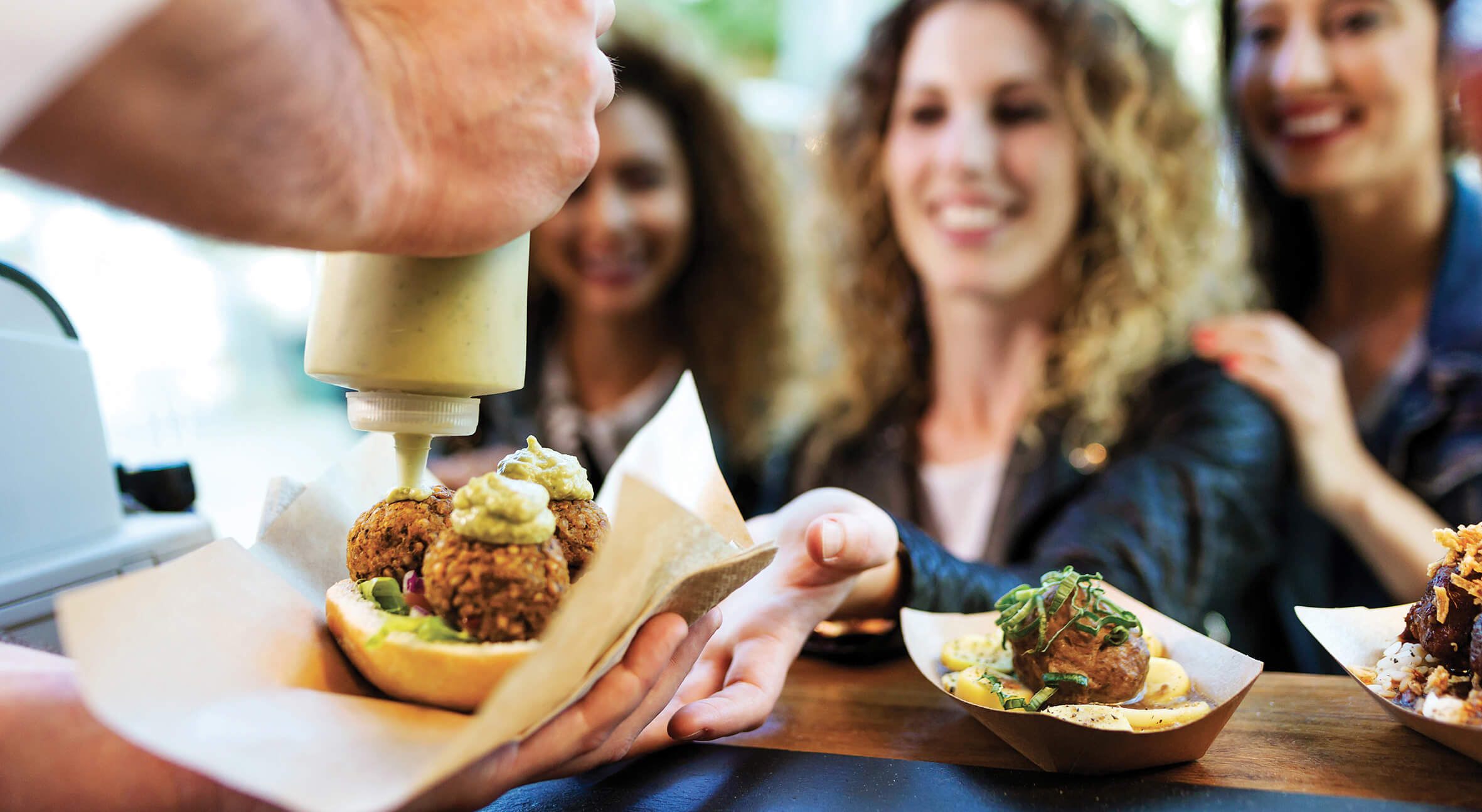 person preparing food in front of customers