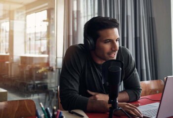 man doing podcast in a bright room