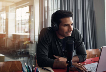 man doing podcast in a bright room