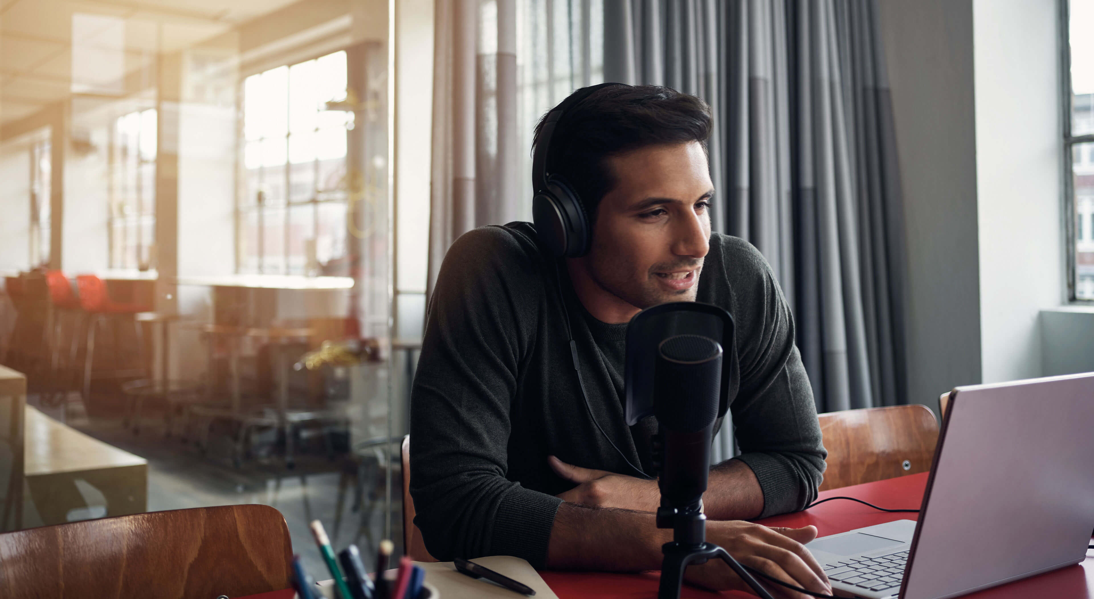 man doing podcast in a bright room