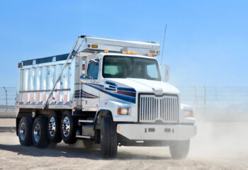 white dump truck on a dusty road