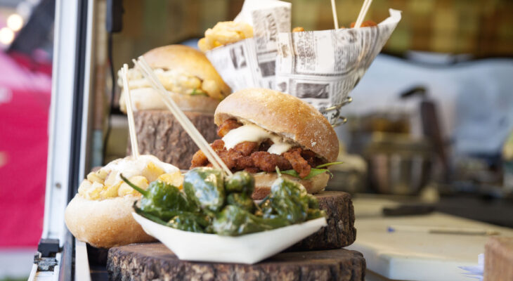 sandwich and sides presented on a wooden plate