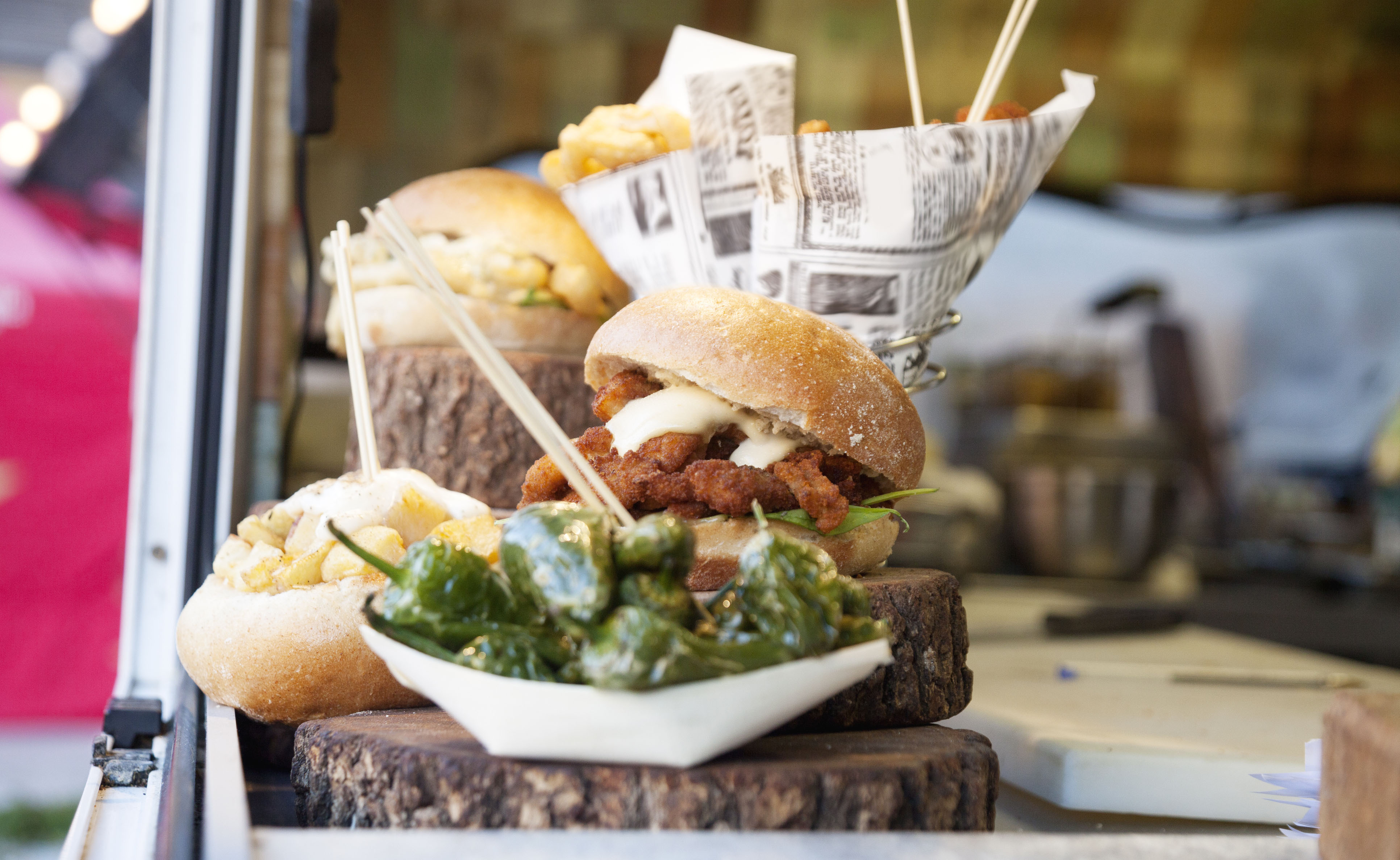 sandwich and sides presented on a wooden plate