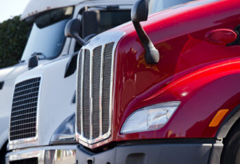 a row of three parked sleeper trucks