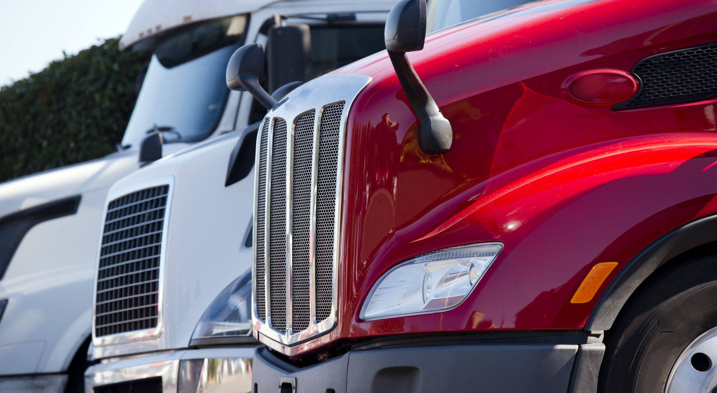 a row of three parked sleeper trucks