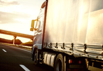 blue truck on a road with bright sunbeam