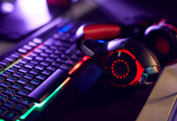RGB gaming keyboard and headset on a desktop