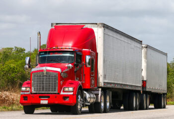 red day cab truck on a highway