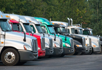 different semi-trailer trucks parked next to each other