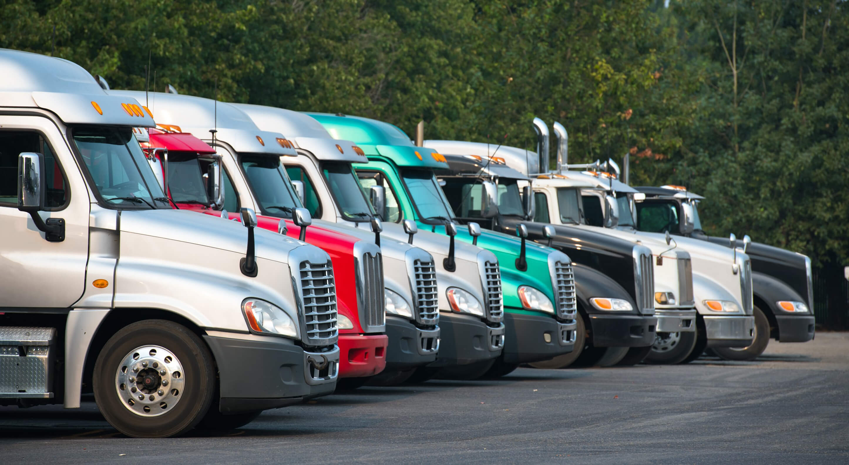 different semi-trailer trucks parked next to each other