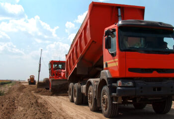 red dump truck on a vacant lot