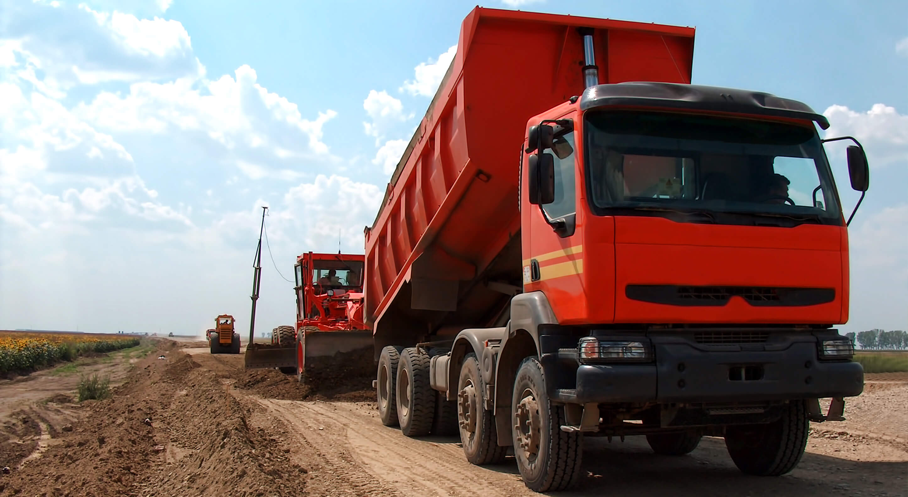 red dump truck on a vacant lot