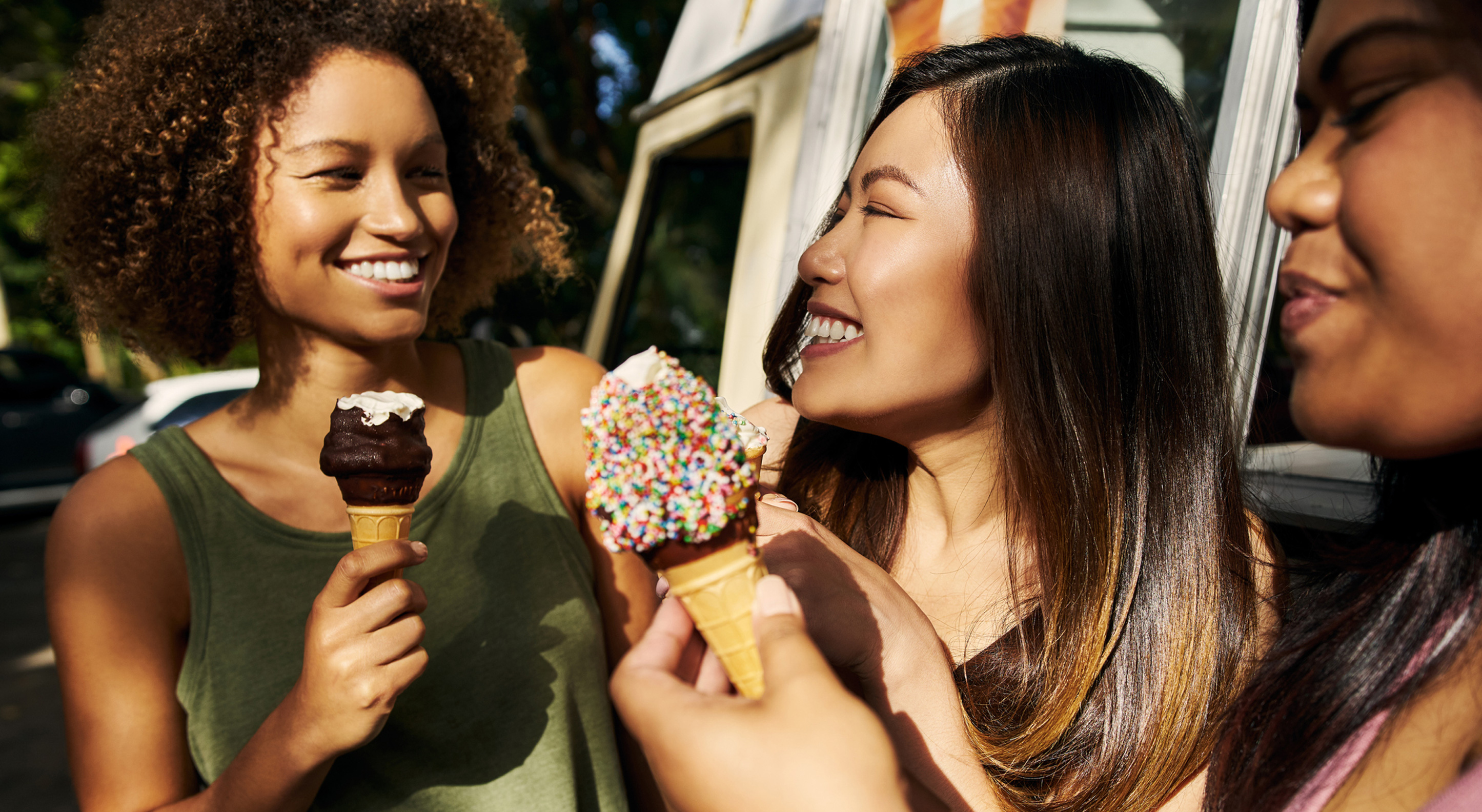 group of three girl friends eating ice cream