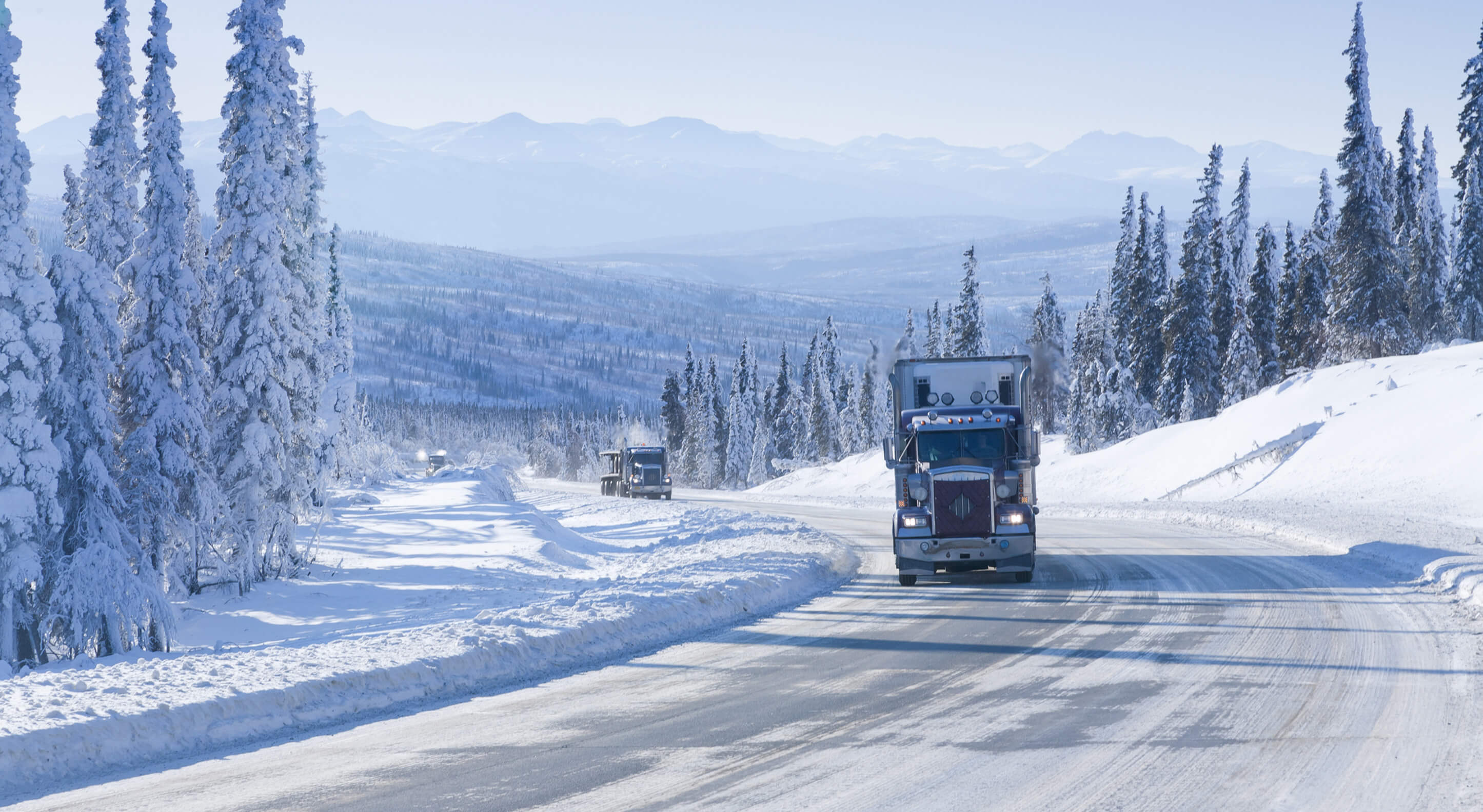 semi-truck driving on Dalton Highway in Alaska