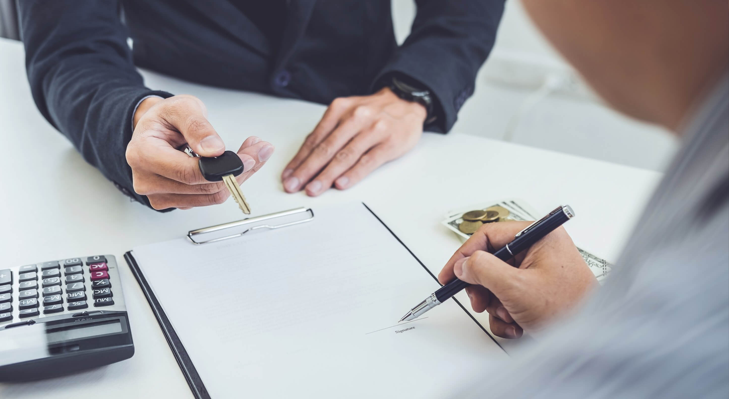 person signing a contract for a truck loan