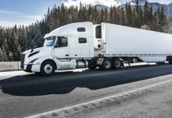 white flatbed truck in a highway