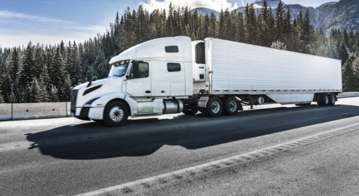 white flatbed truck in a highway