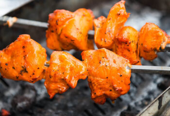 preparation of chicken tikka masala at a food truck during a food festival