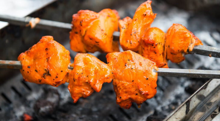 preparation of chicken tikka masala at a food truck during a food festival