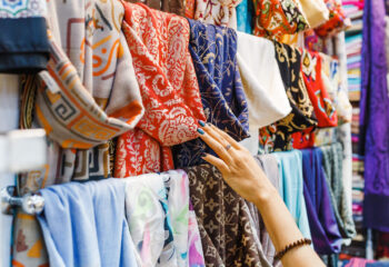 young woman shopping for a new colorful scarf at a mobile boutique