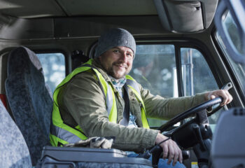 male truck driver sitting in his semi truck