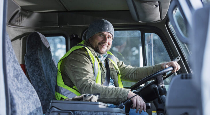 male truck driver sitting in his semi truck