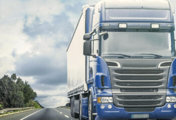 blue semi truck on a deserted highway