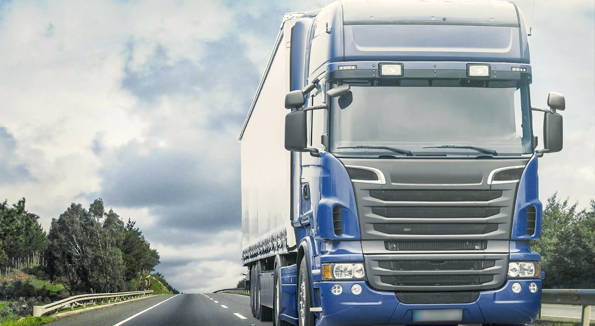 blue semi truck on a deserted highway