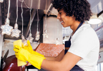 food truck employee cleaning the food truck ornaments