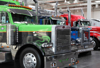 peterbilt trucks displayed at an auto show