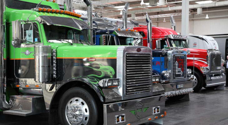 peterbilt trucks displayed at an auto show