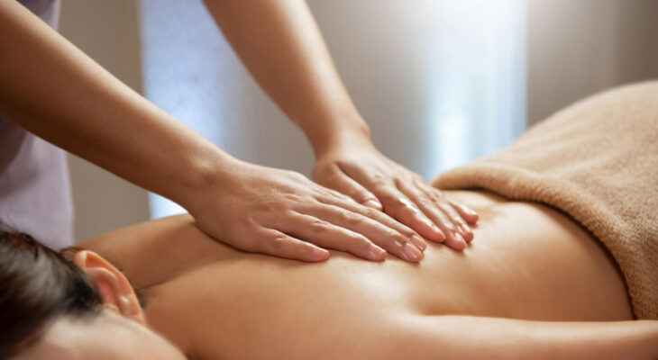 masseuse doing massage on a female body in the spa salon