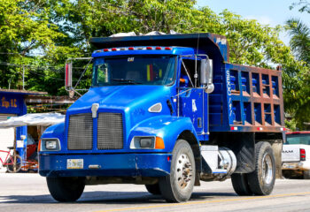 blue Kenworth T300 dump truck in the town street