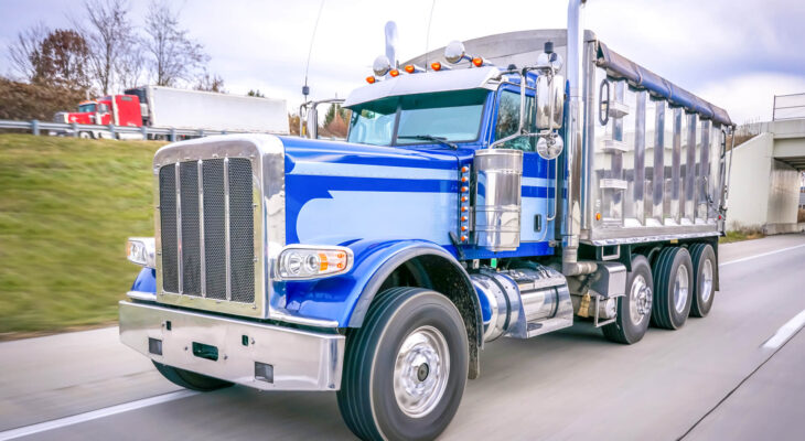 blue dump truck on a highway