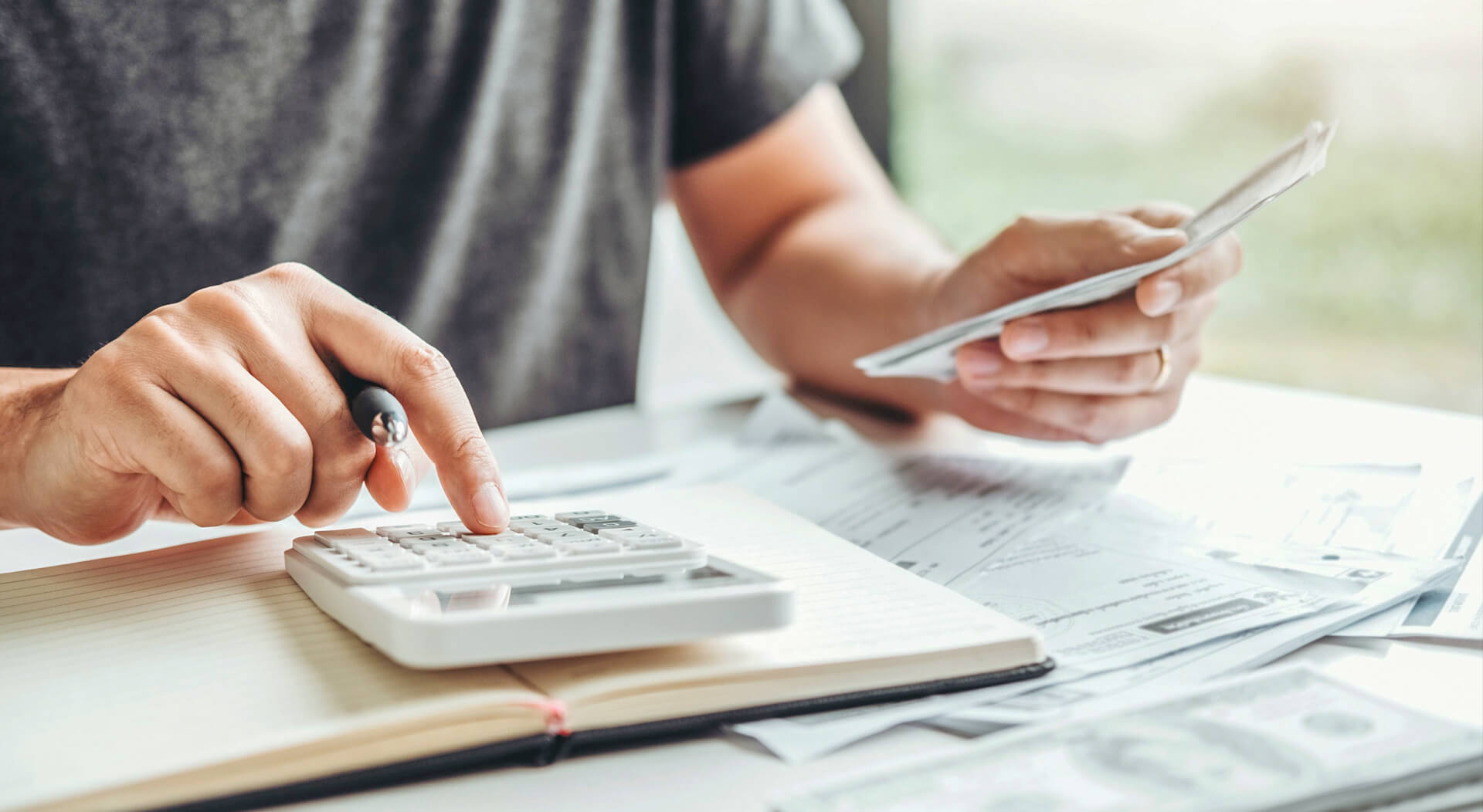 food truck business owner using calculator to track business costs