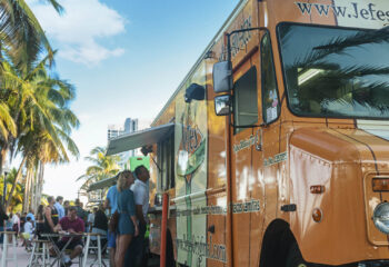 A food truck convoy serving a variety of delicious food making business at Miami Beach on a quiet Wednesday afternoon at a food truck fair