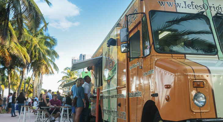 A food truck convoy serving a variety of delicious food making business at Miami Beach on a quiet Wednesday afternoon at a food truck fair