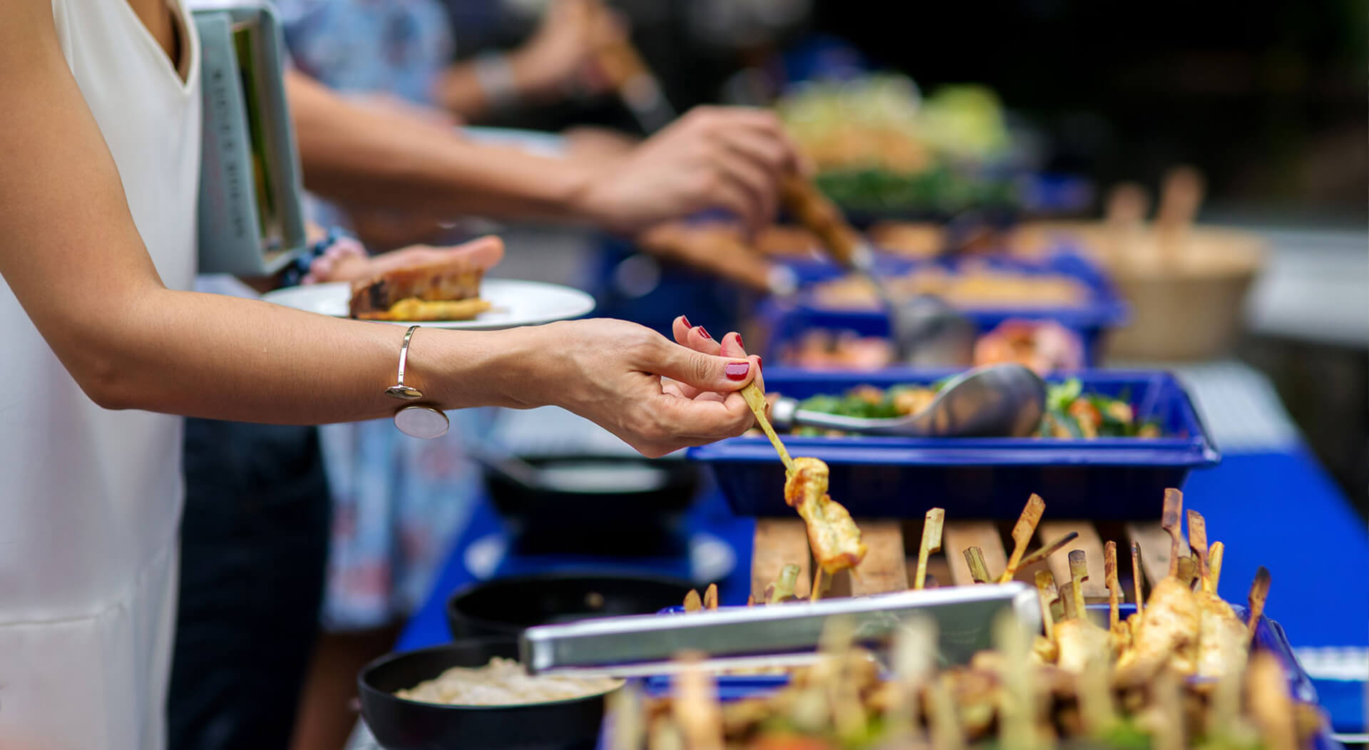 woman taking food from a food tray