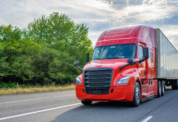 heavy loaded red semi truck transporting commercial cargo